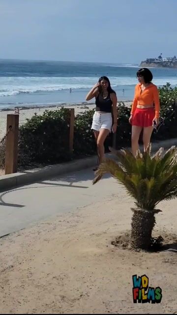 Velma costume, fully clothed, beach boardwalk, normal framing