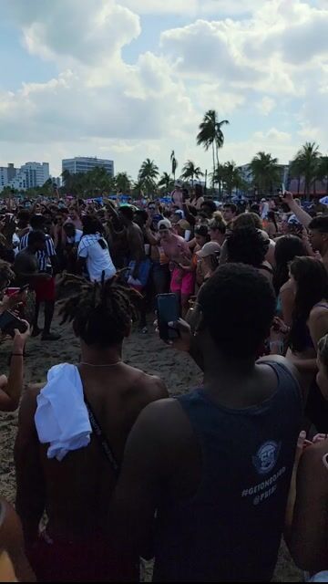 Large beach crowd in swimwear