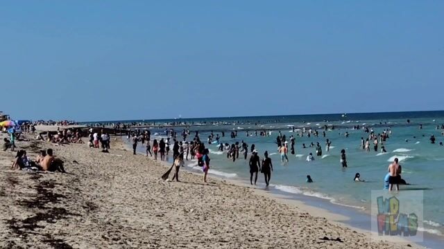 Wide beach crowds, swimwear