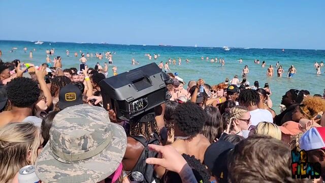 Beach party crowd, wide shots, swimwear in normal context