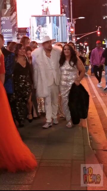 Women in evening gowns on street at night, fully clothed