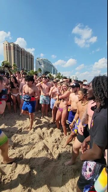 Beach crowd in normal swimwear; playful context