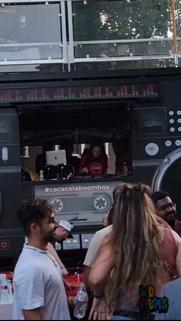 Street festival, fully clothed crowd, DJ stage