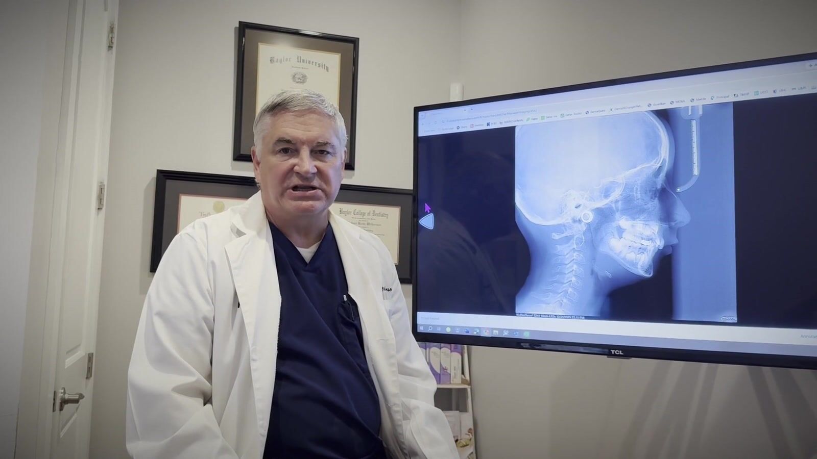 Still from the course trailer: Dr. Keith Wilkerson in his practice, beside a lateral cephalometric radiograph