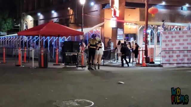 Street dance performance at night; everyone fully clothed