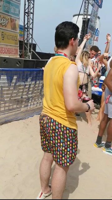 Beach party crowd dancing in bikinis, normal context