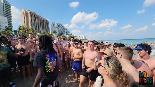 Bikini boxing: clothed in swimwear, public beach, physical play not sexualized