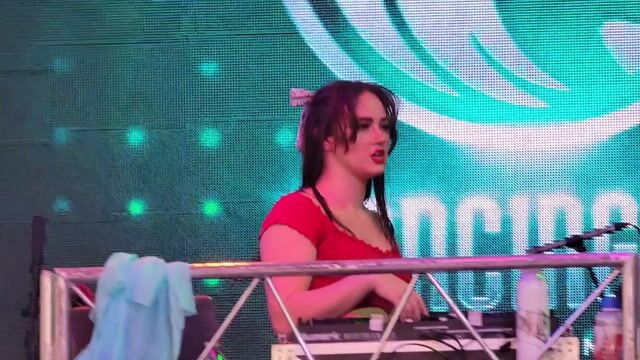 Woman DJ fully clothed performing on stage