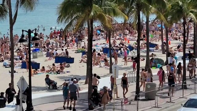 Aerial street/beach scenes; ordinary swimwear in normal beach context